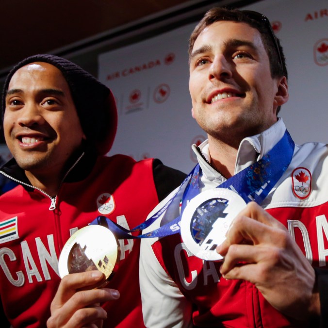 Denny Morrison, right, and Gilmore Junio arrive home from the Sochi Olympics in Calgary