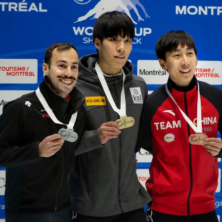 steven dubois on the podium posing with his silver medal alongside the gold and bronze medal