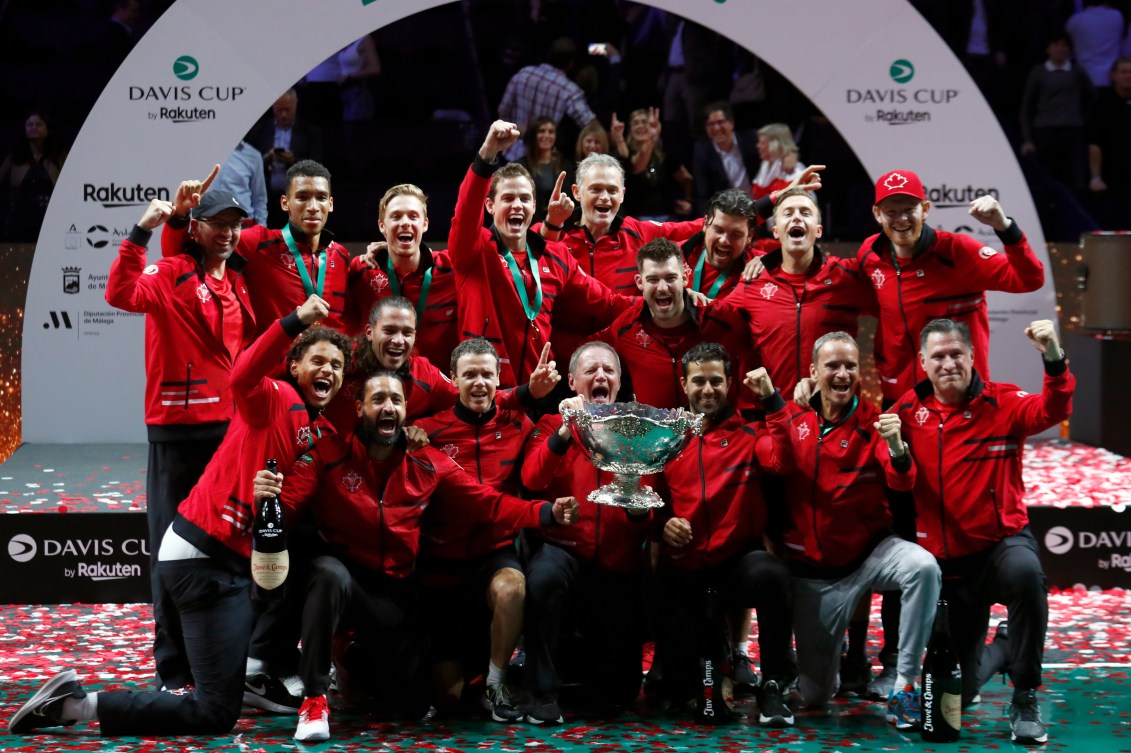 Canadian players and staff celebrate with the Davis Cup trophy