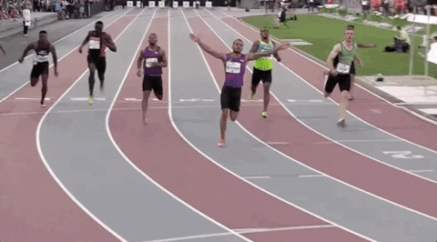 A gif of Andre De Grasse with his arms in the air celebrating while running.