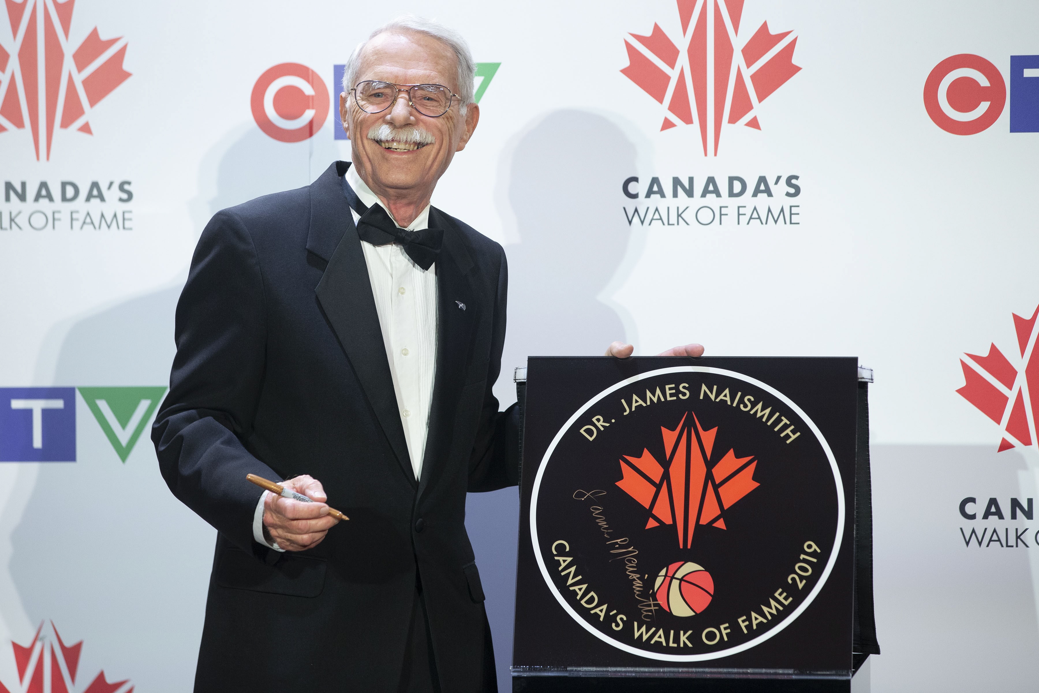 Jim Naismith, the grandson of Dr.James Naismith, the inventor of basketball, pictured with his grandfather's star.