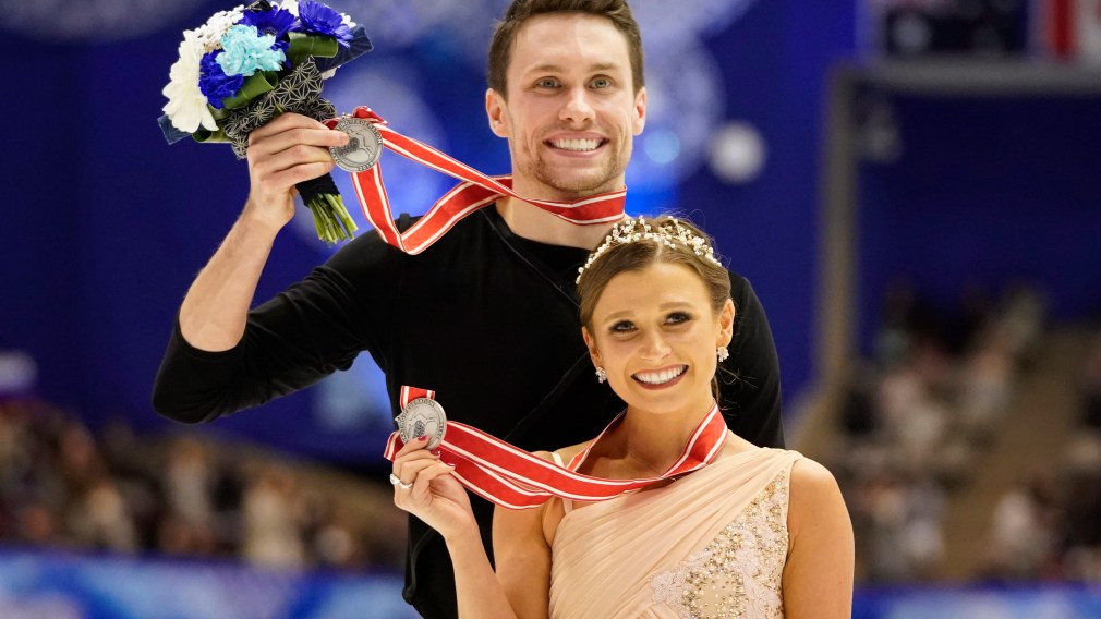 Silver medalists Kirsten Moore-Towers and Michael Marinaro of Canada pose with their medals at a victory ceremony for the pairs free skating program during the ISU Grand Prix of Figure Skating