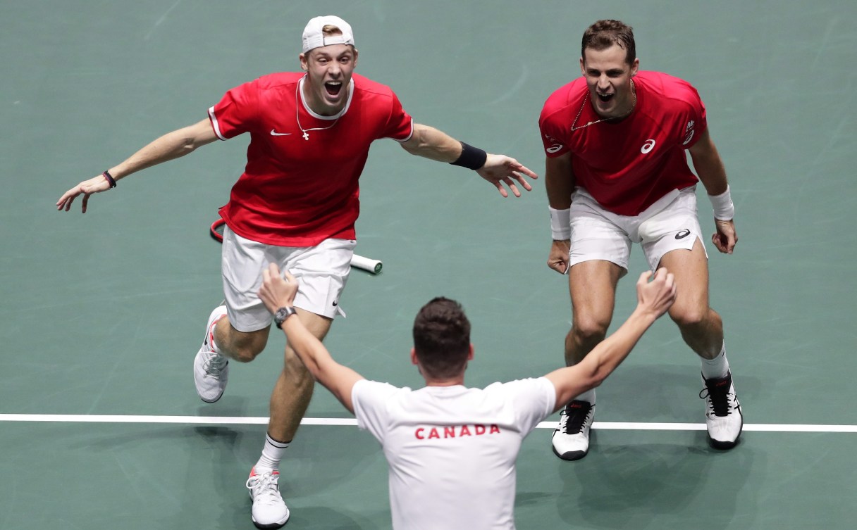 Denis (left) and Vasek run towards Frank (centre) after winning their semis match.