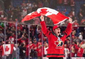 Dillon Dube celebrating with flag