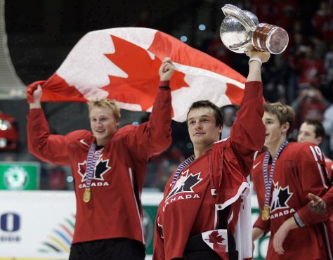 Team Canada players celebrate with flag