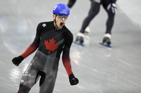 Canada's Jordan Belchos celebrates after winning gold at the ISU Speed Skating World Cup