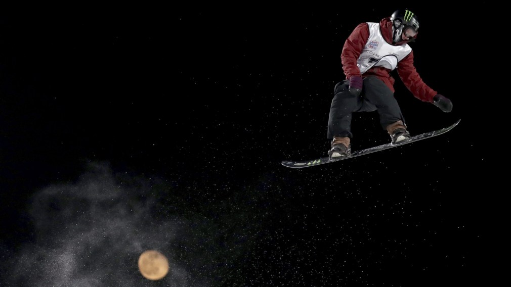 Canada's Darcy Sharpe jumps, backdropped by the moon, in the Men's Snowboard Big Air for the 2019 FIS Big Air World Cup held at the Big Air Shougang in Beijing on Saturday, Dec. 14, 2019. (AP Photo/Ng Han Guan) ///
