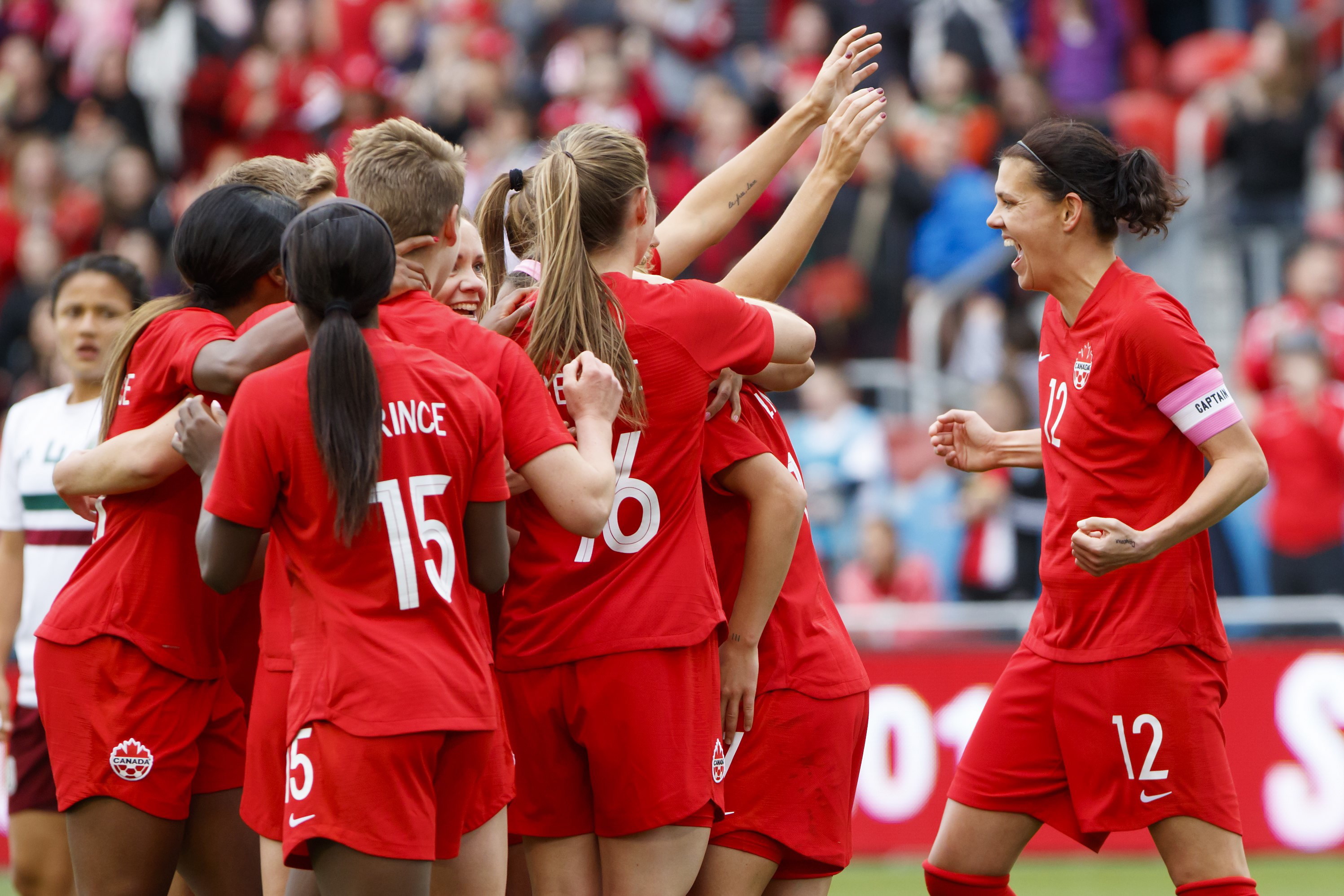 Team Canada celebrates after scoring a goal.