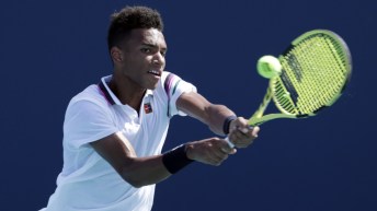 Felix Auger-Aliassime returns a shot