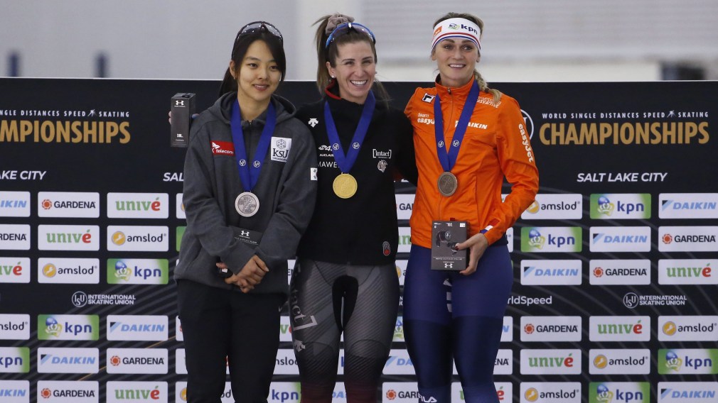 Speed skating medallists stand on podium after competing in women's mass start