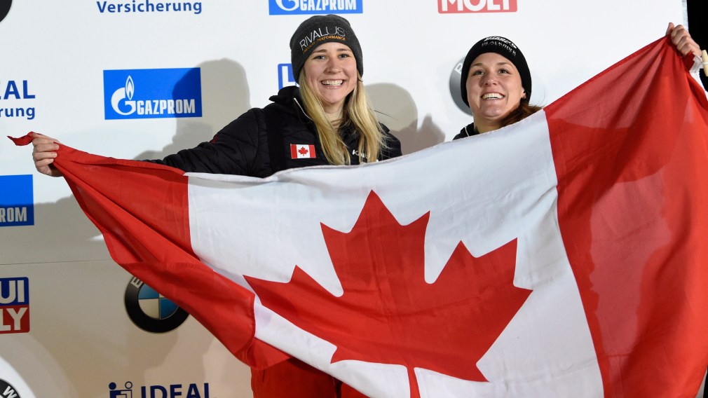 Bronze medalists Canada's Christine de Bruin, right, and Kristen Bujnowski celebrate during medal ceremony for the two-woman bobsled competition at the Bobsleigh and Skeleton World Championships in Altenberg, Germany, Saturday, Feb. 22, 2020. (AP Photo/Jens Meyer)