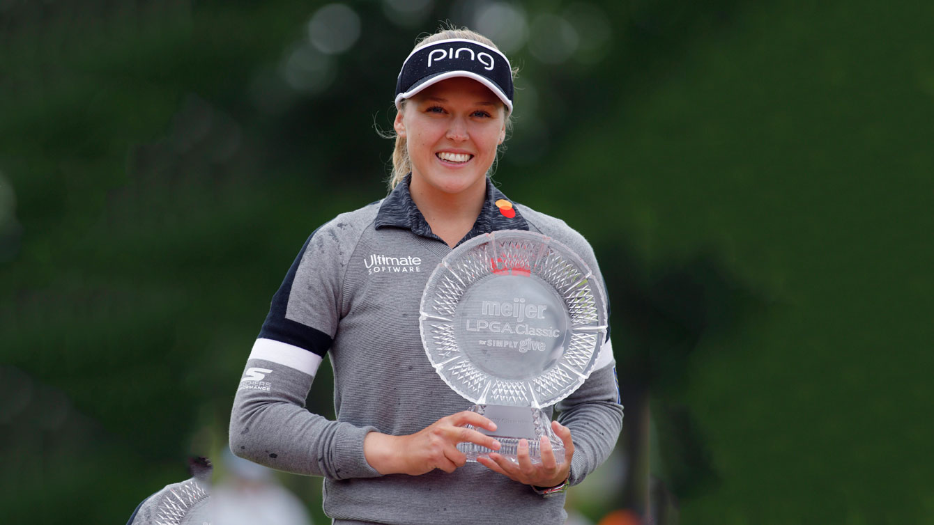 Brooke Henderson, of Canada, holds the championship trophy after winning the Meijer LPA Classic golf tournament, Sunday, June 16, 2019, in Grand Rapids, Mich. (AP Photo/Al Goldis)