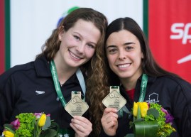 Meaghan Benfeito, right, and Caeli McKay of Canada hold up their gold medals after winning the women's 10-metre platform synchro final.