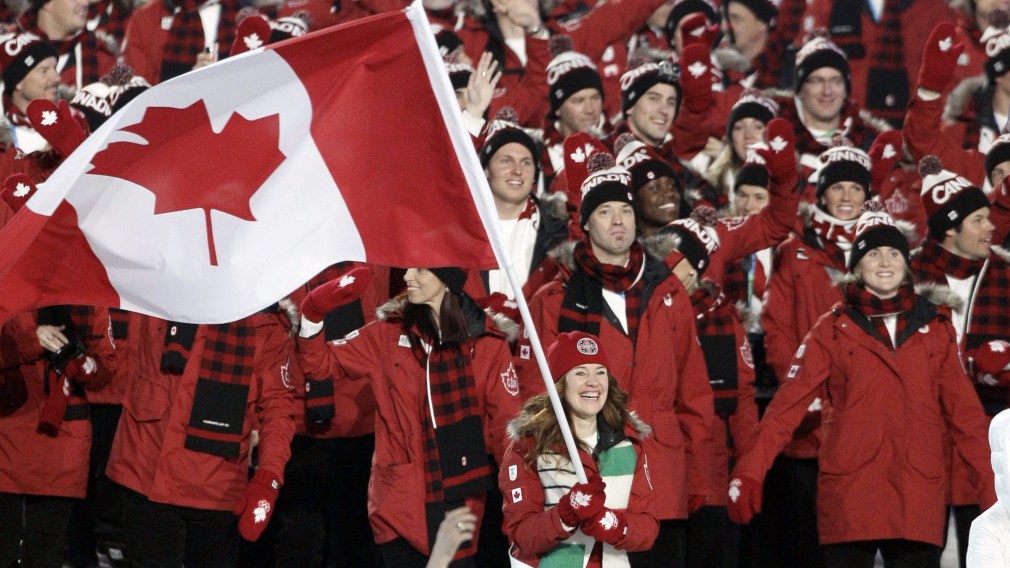 Les athlètes canadiens entrent dans le stade, menés par Clara Hughes