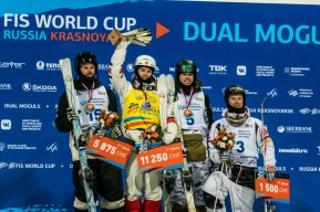 Mikael Kingsbury stands on the top step of the podium after winning gold in men's dual moguls
