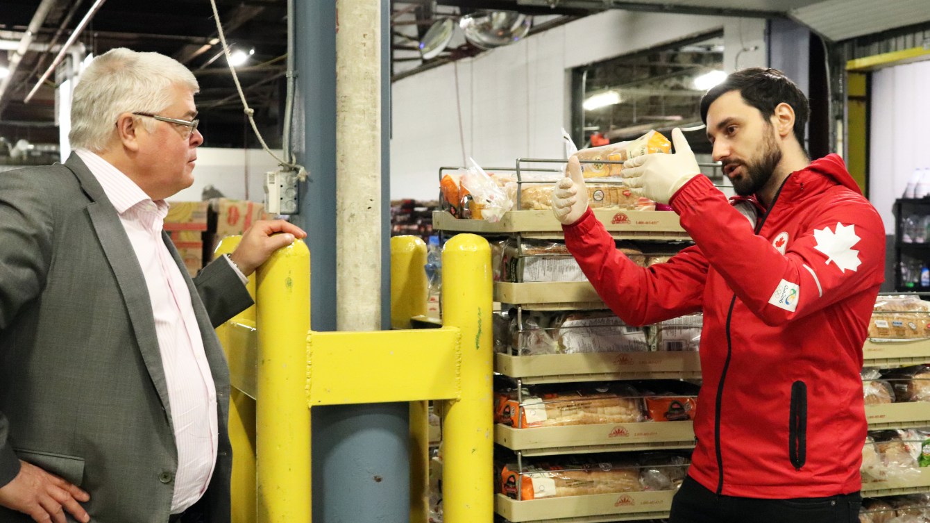 Joseph Polossifakis (right) speaks to an old gentleman who is a staff member at Moisson Montreal.