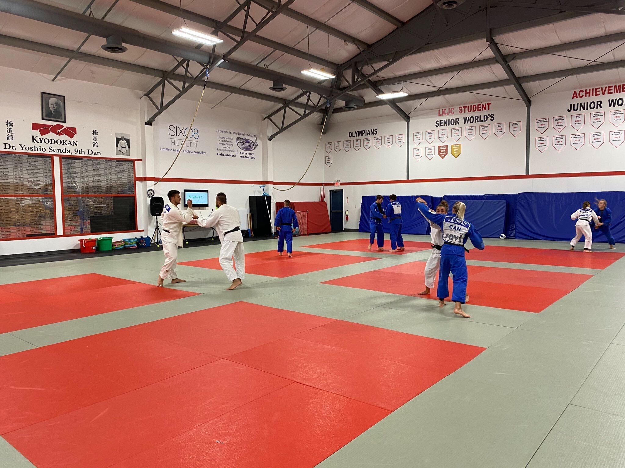 Judo team members practice in a dojo