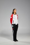 Douglas side view with hands in jacket pocket that has red arms white body, and black pants