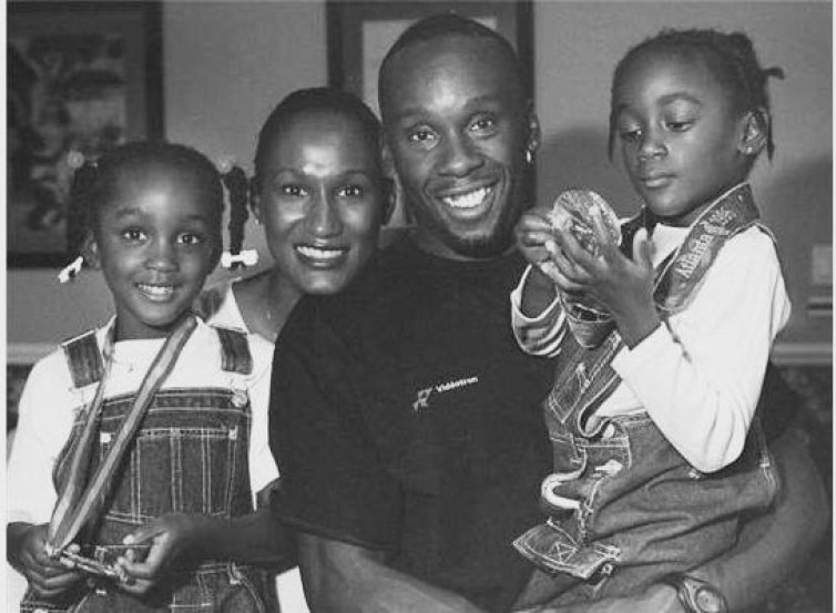 Bruny Surin and his young daughters wearing his medals
