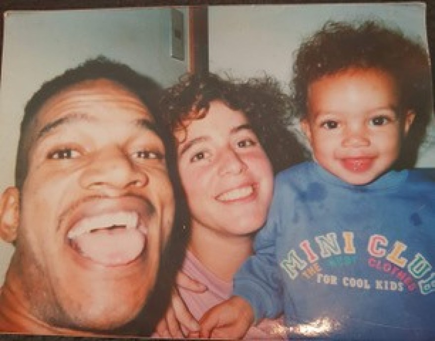 A young Brandie Wilkerson takes a photo with her parents