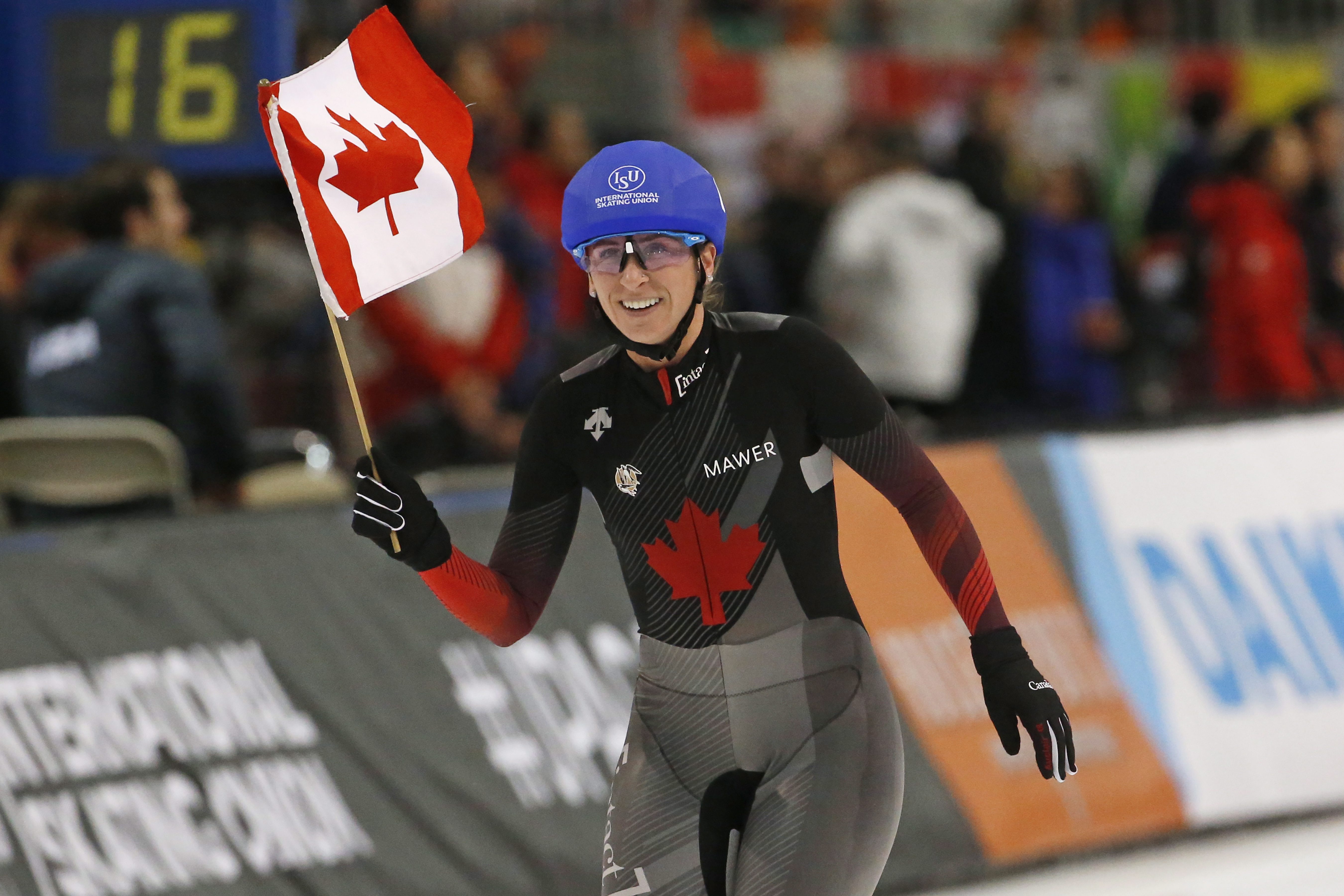 Speed skater takes victory lap waving Canadian flag 