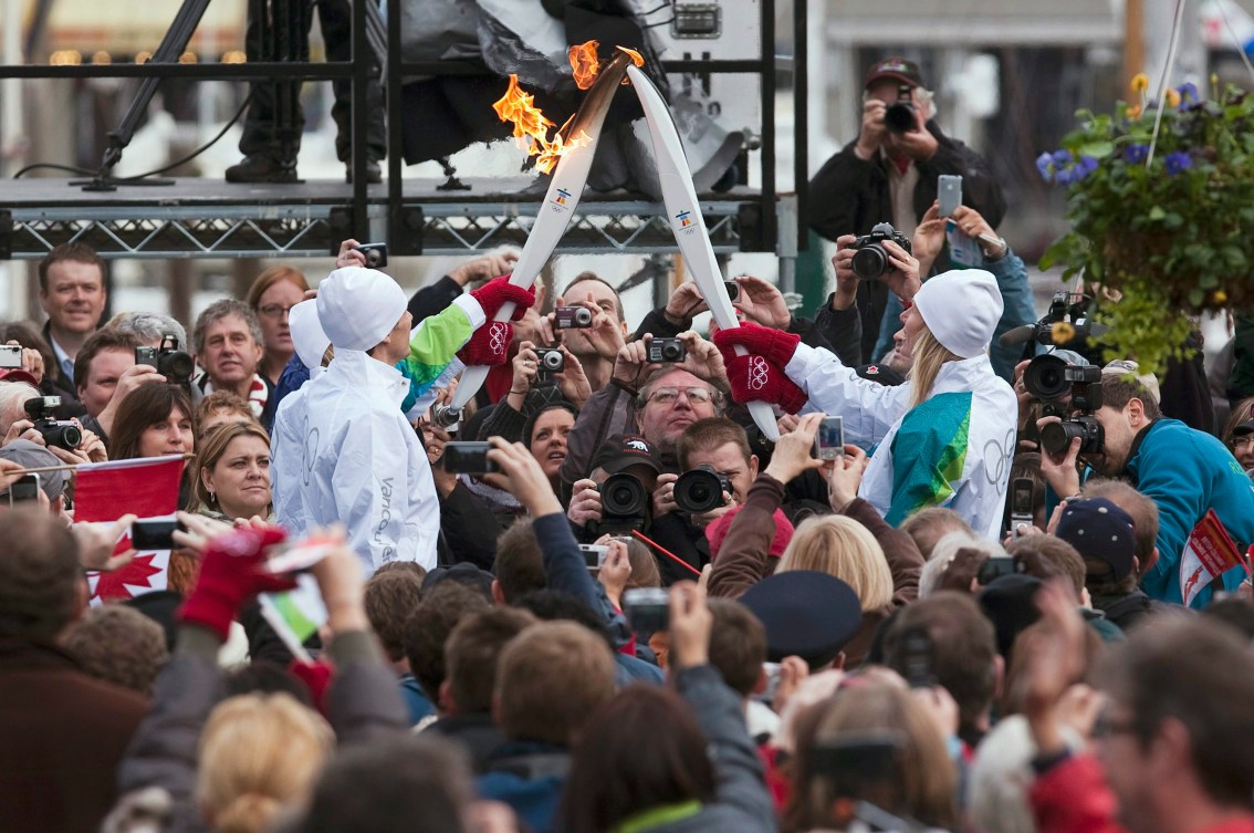 Two torches are touched to pass the flame