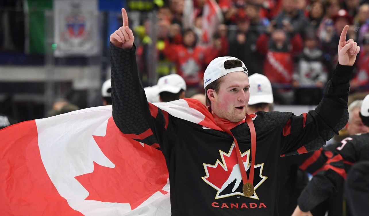 Alexis Lafreniere celebrates after winning gold.