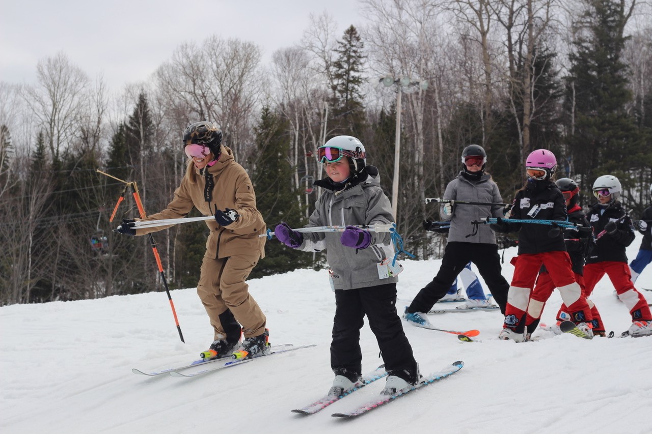 Young skiers going down a hill 