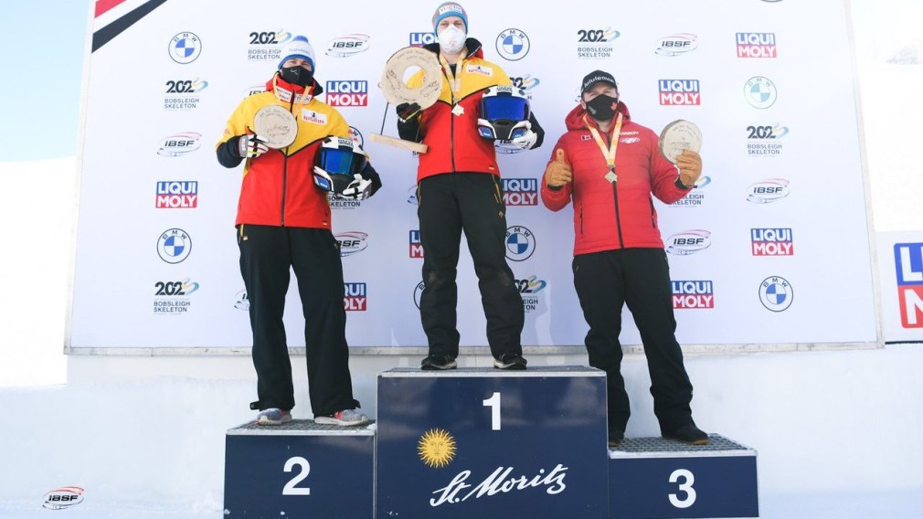 Justin Kripps stands on the podium as Kripps and Cam Stones won their first two-man bobsleigh medal of the World Cup season on Saturday in St. Moritz, Switzerland. (Photo by: IBSF/Viesturs Lacis)