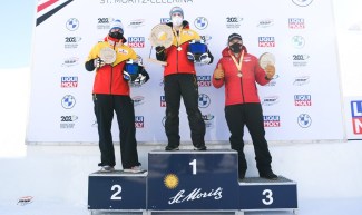 Justin Kripps stands on the podium as Kripps and Cam Stones won their first two-man bobsleigh medal of the World Cup season on Saturday in St. Moritz, Switzerland. (Photo by: IBSF/Viesturs Lacis)