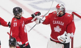 Canada's Kaiden Guhle (21) and goalie Devon Levi (1) celebrate their win over the Czech Republic during IIHF World Junior Hockey Championship action in Edmonton on Saturday, January 2, 2021. THE CANADIAN PRESS/Jason Franson