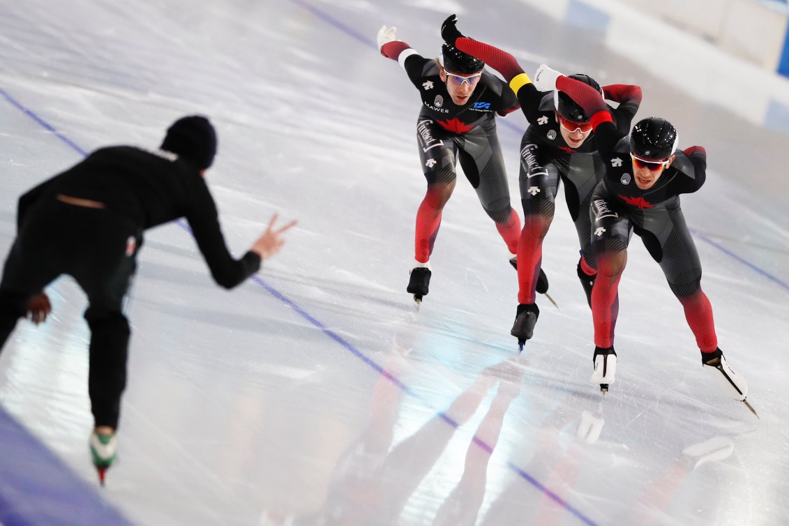 Ted-Jan Bloemen, white armband, Jordan Belchos, red armband and Connor Howe, yellow armband, compete during the men's team pursuit race.