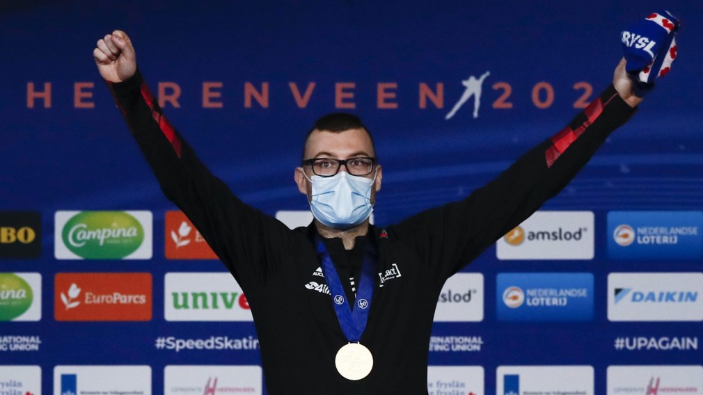 Canada's Laurent Dubreuil celebrates with his gold medal on the podium of the men's 500 meters race of the World Championships Speedskating Single Distance at the Thialf ice arena in Heerenveen, northern Netherlands, Friday, Feb. 12, 2021. (AP Photo/Peter Dejong)