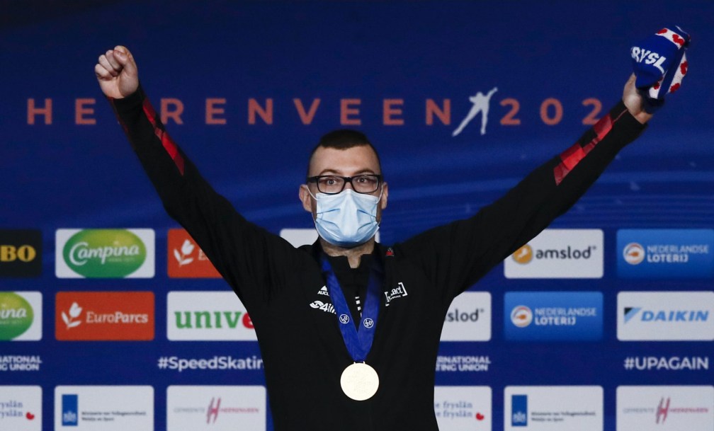 Canada's Laurent Dubreuil celebrates with his gold medal on the podium of the men's 500 meters race of the World Championships Speedskating Single Distance at the Thialf ice arena in Heerenveen, northern Netherlands, Friday, Feb. 12, 2021. (AP Photo/Peter Dejong)