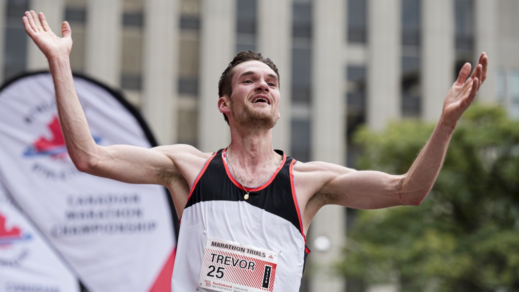 Man with arms raised in triumph at the end of a race