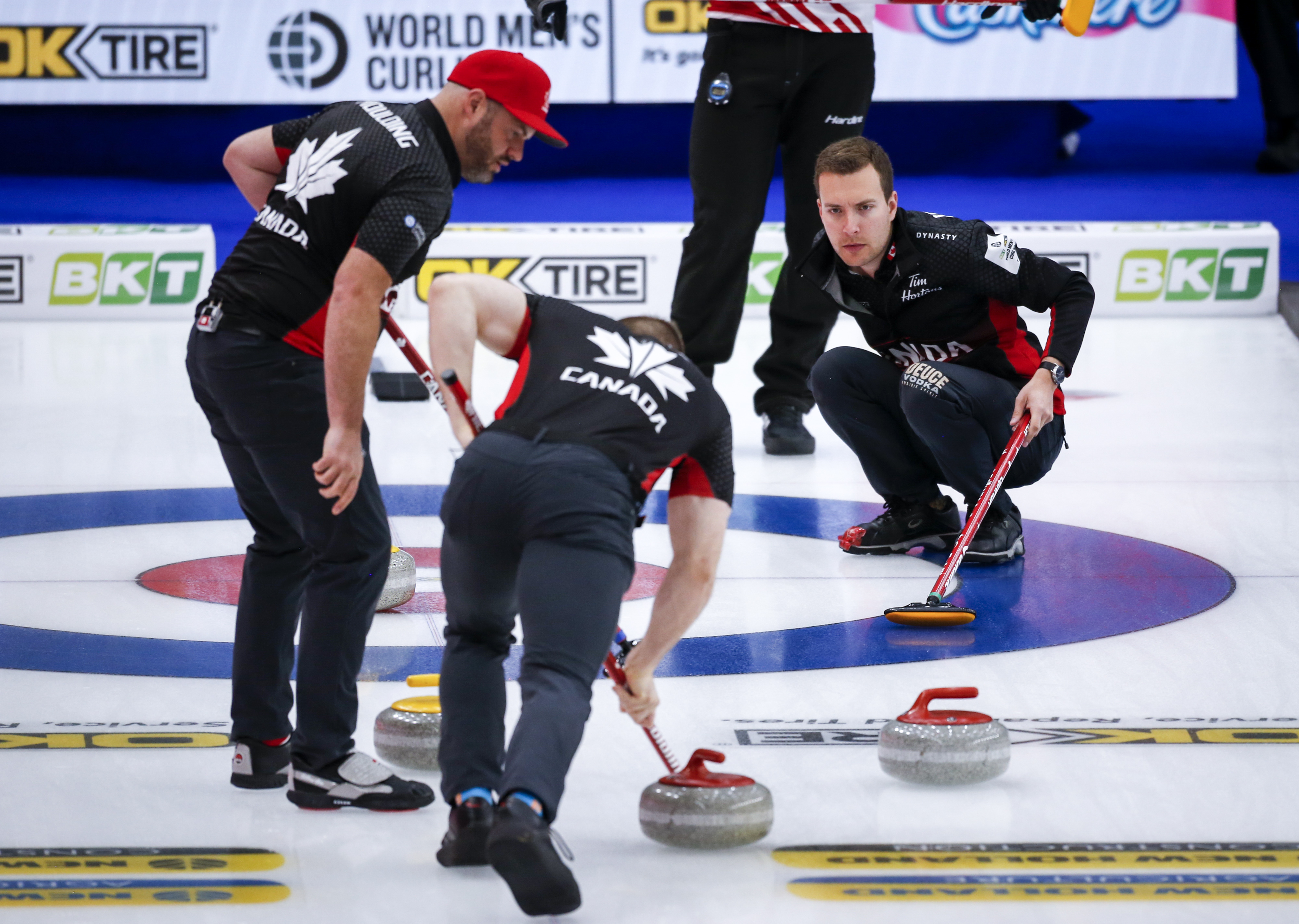Team Canada skip Brendan Bottcher, centre, directs his teammates as they play Denmark at the Men's World Curling Championships in Calgary, Alta., Saturday, April 3, 2021.