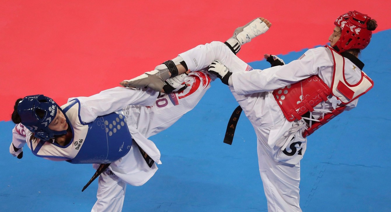 Anastasija Zolotic of the United States, right, competes with Skylar Park of Canada in the women's under 57kg Taekwondo event at the Pan American Games in Lima, Peru, Sunday, July 28, 2019. Zolotic won the gold.