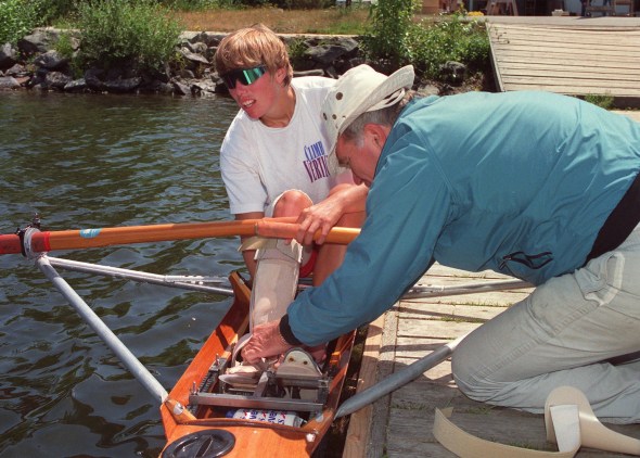 Rower Silken Laumann receives assistance adjusting her leg brace in Victoria Wednesday, June 17, 1992 from friend Peter Smith. Laumann has returned to rowing to help recover from injuries received last month at a meet in Germany.