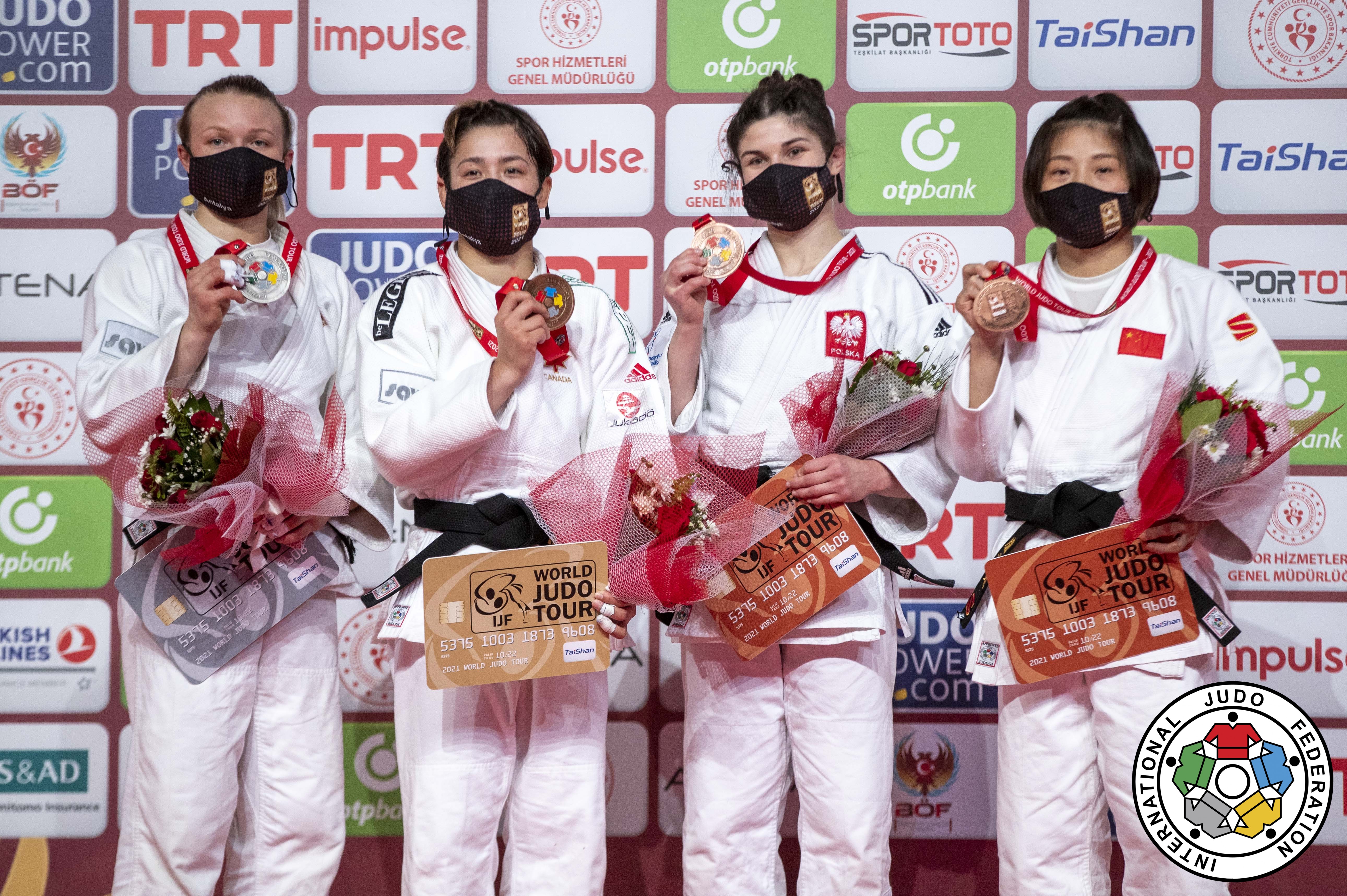Four female judokas on podium