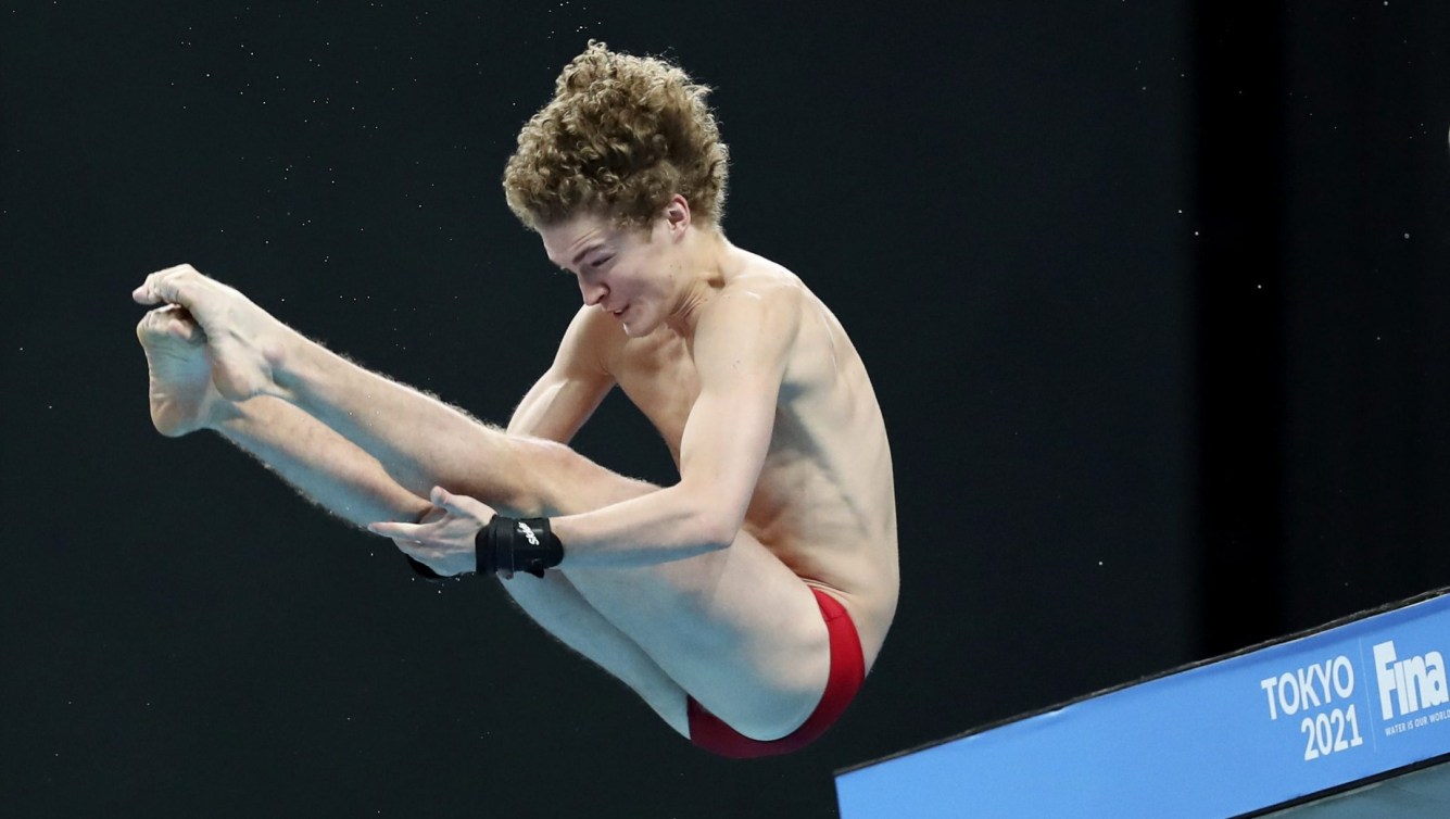 Male diver in pike position in air