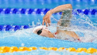Rebecca Smith swims freestyle in a race