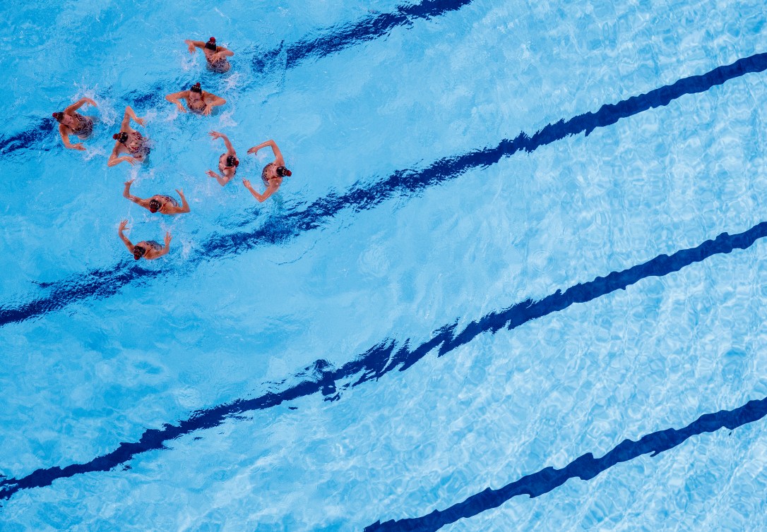 artistic swimmers performing in the water