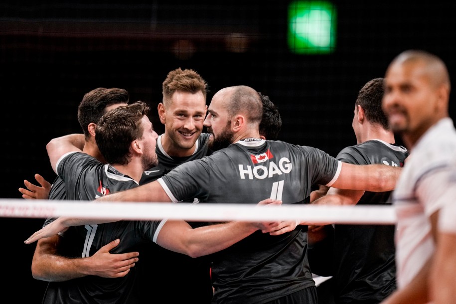 Canadian volleyball players celebrating on the court