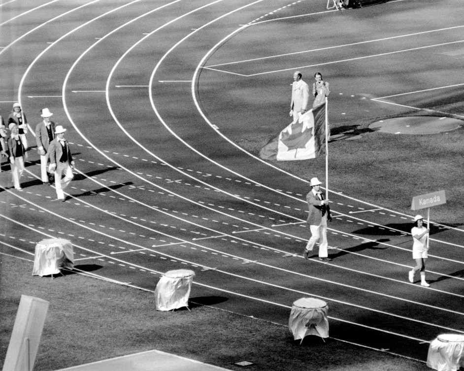 Doug Rogers carries Canadian flag into Olympic Stadium