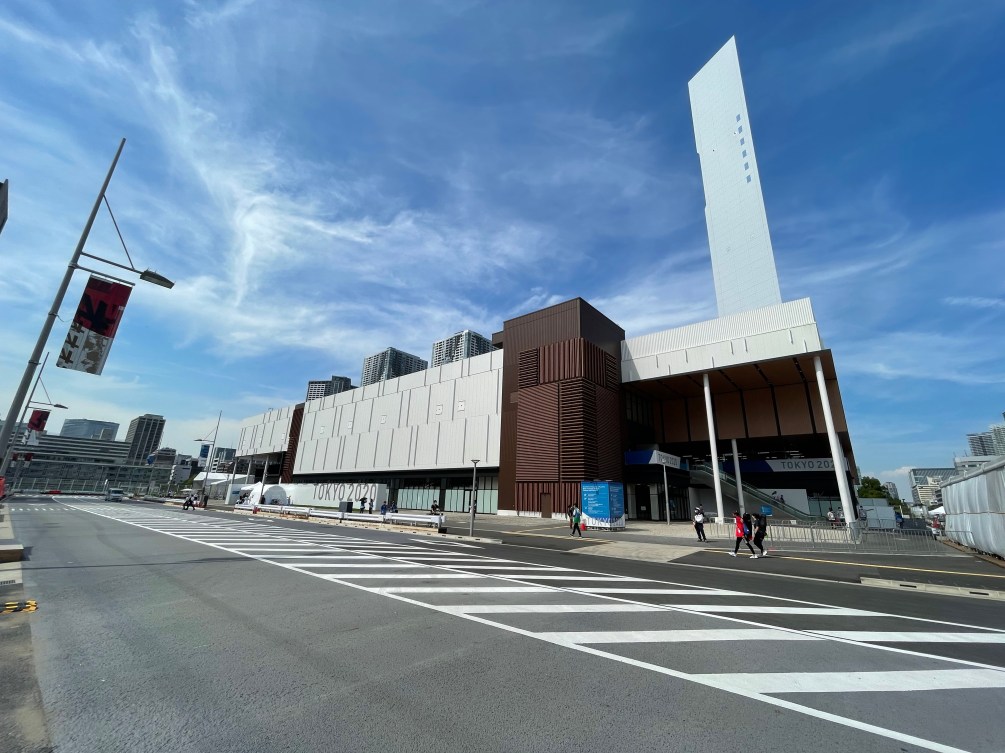 Large brown and white building situated on the right ride of the street that is the site of the fitness centre for the 2020 Games