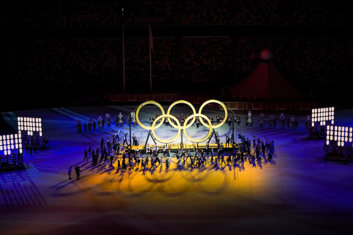 Wooden Olympic Rings are pictured at the Opening Ceremony, surrounded by performers.