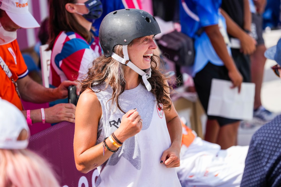 Annie Guglia smiles in skateboarding gear