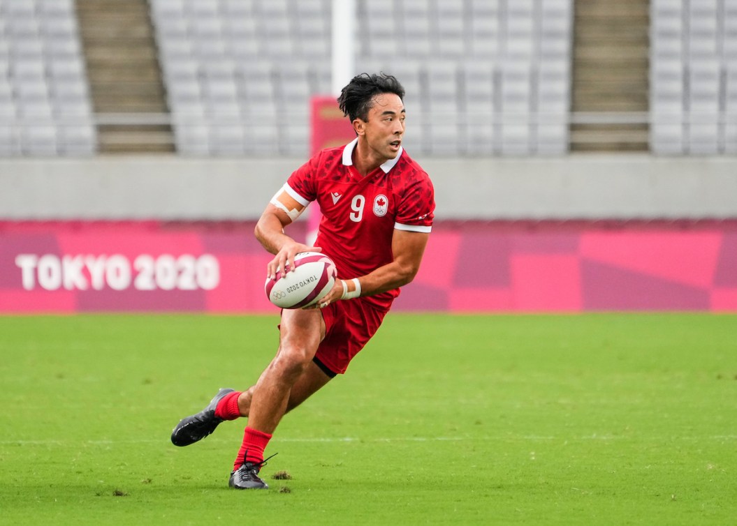 Nathan Hirayama prepares to pass the ball in a rugby match