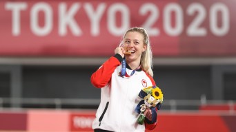 Kelsey Mitchell bites gold medal on the podium