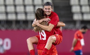 Christine Sinclair celebrates in teammate Jordyn Huitema's arms